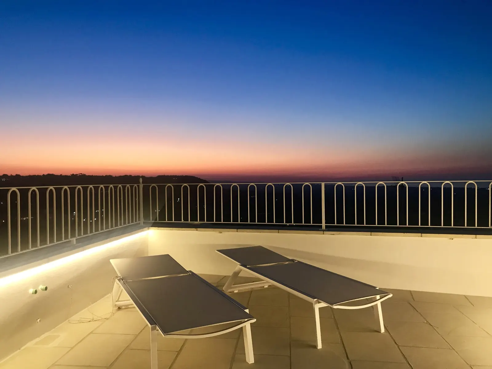 Sun loungers on the terrace at dusk
