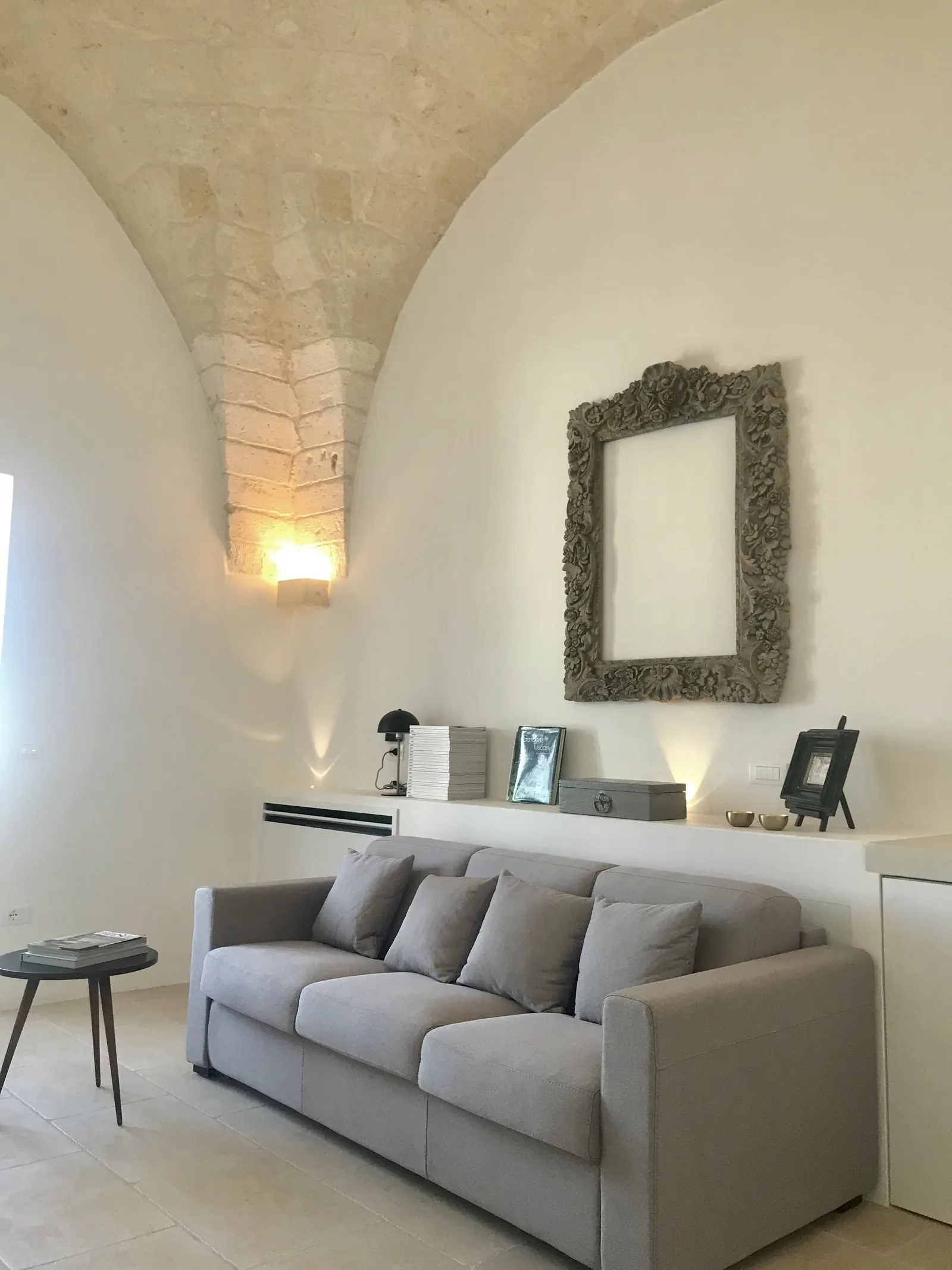 Sitting room with sofa and antique mirror