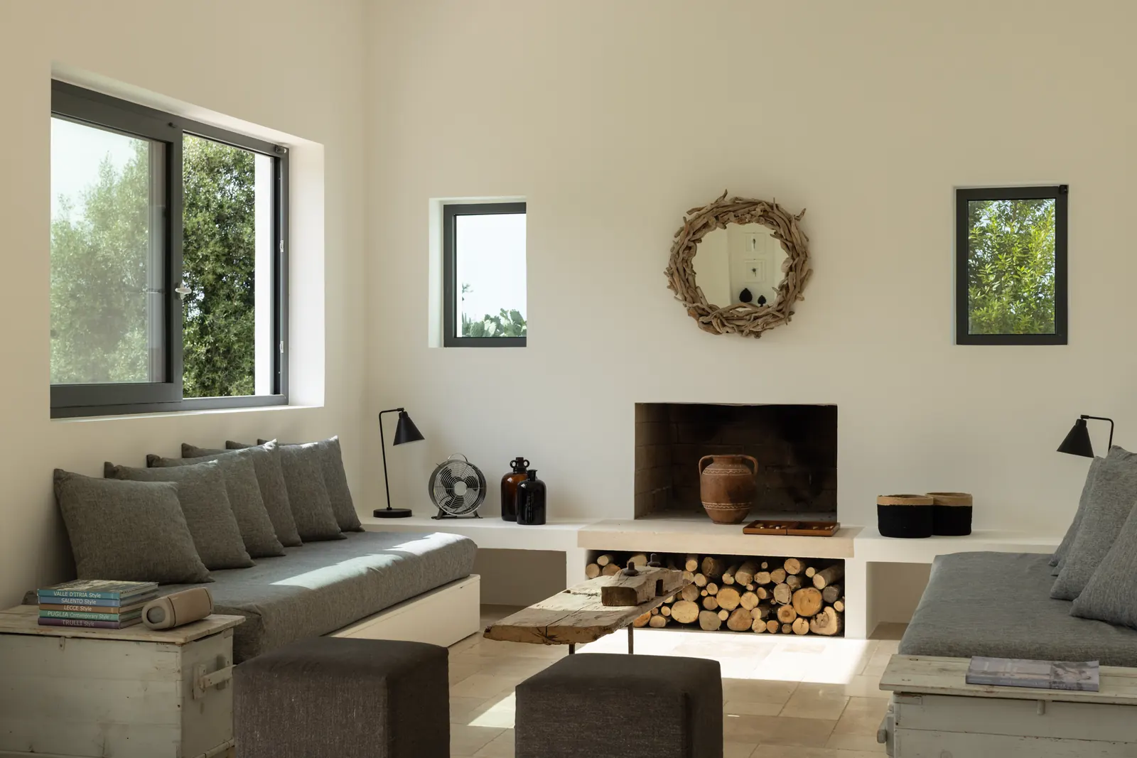 Sitting room with a woven mirror above the fireplace