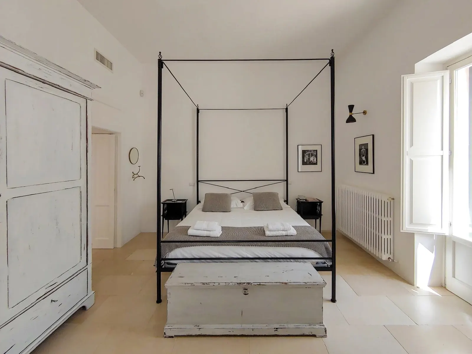 Bedroom with four-poster bed and painted wardrobe