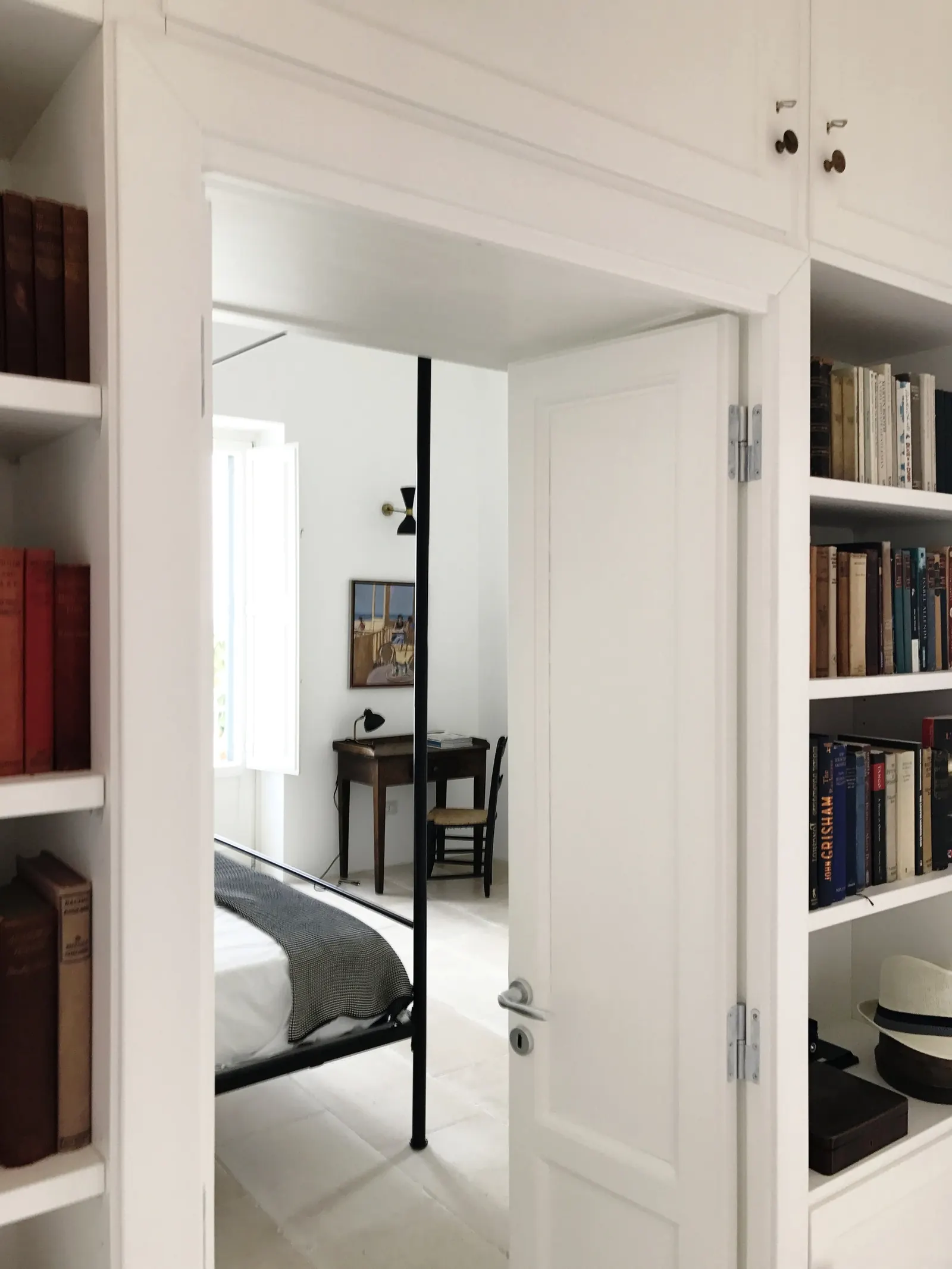 Bookshelves framing the bedroom door