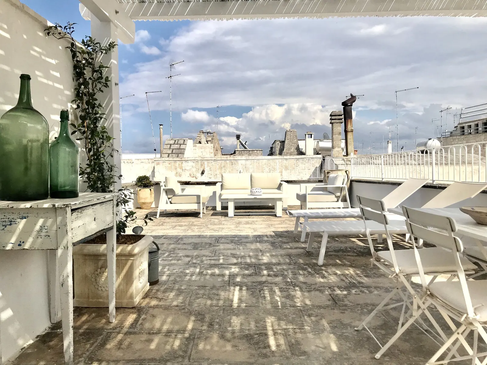 Terrace dining table and green glass bottles