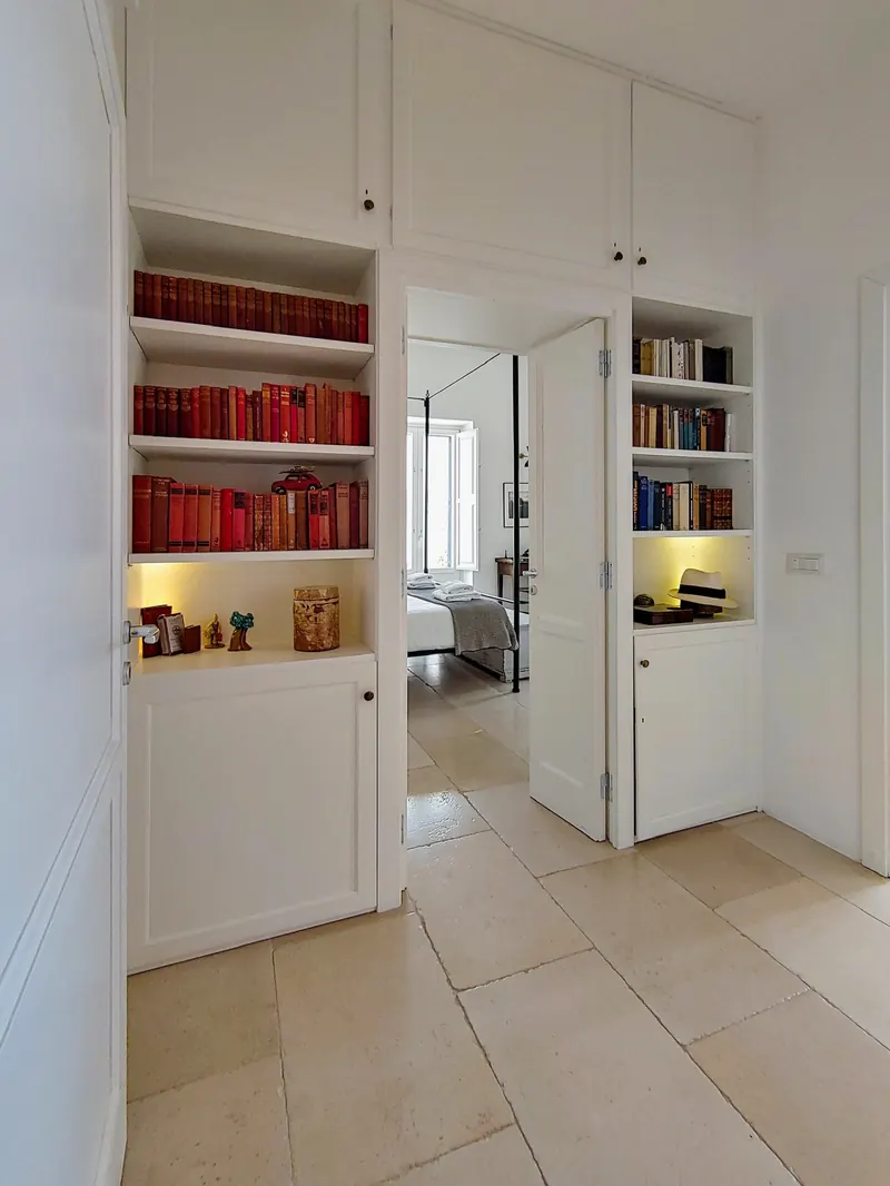 Red bookshelves by the hallway