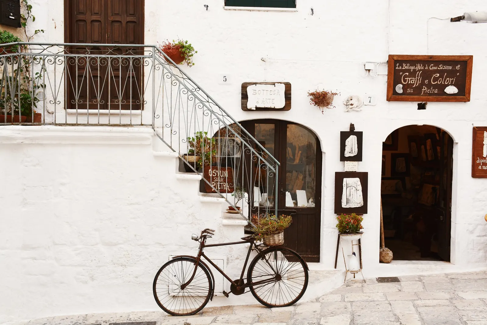 A bicycle below whitewashed steps in the old town