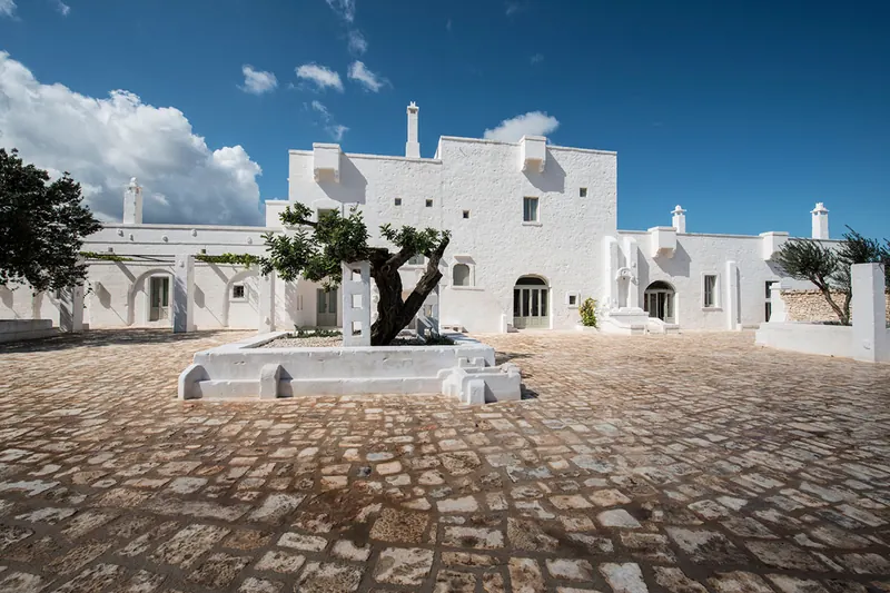 The stone courtyard of Masseria Le Carrube