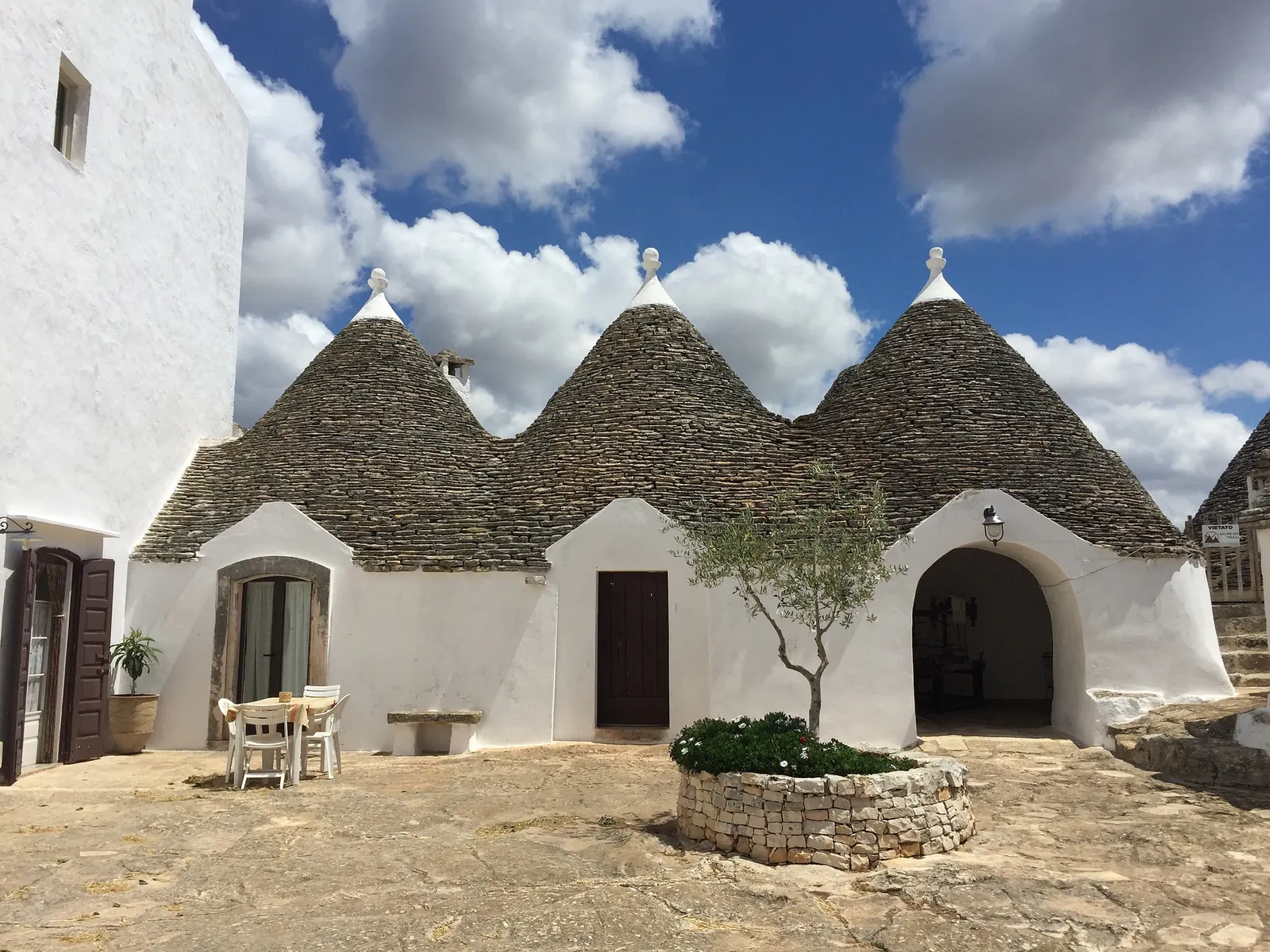 A row of trulli with conical stone roofs